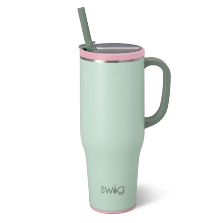 Mint green mug with pink rim and straw on a white background, featuring the 'swig' brand.