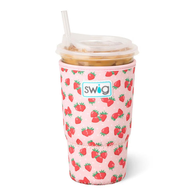 Pink tumbler with strawberry pattern and straw on a white background