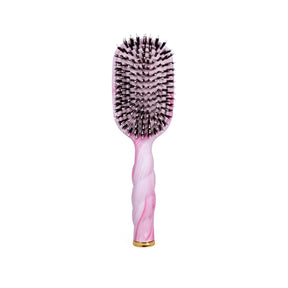 Hairbrush with pink handle and black bristles on a white background