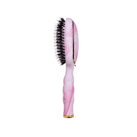 Pink hairbrush with bristle head on a white background