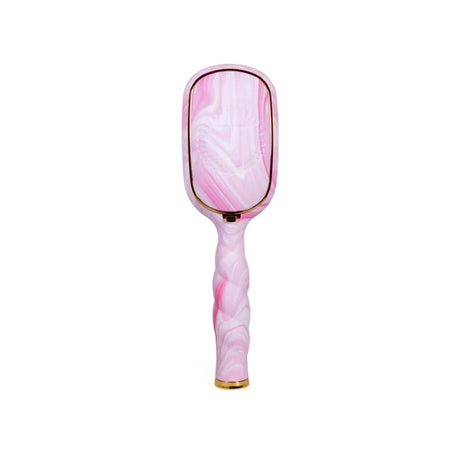 A pink and white marbled handheld mirror with a twisted handle and gold trim, shown against a plain white background.