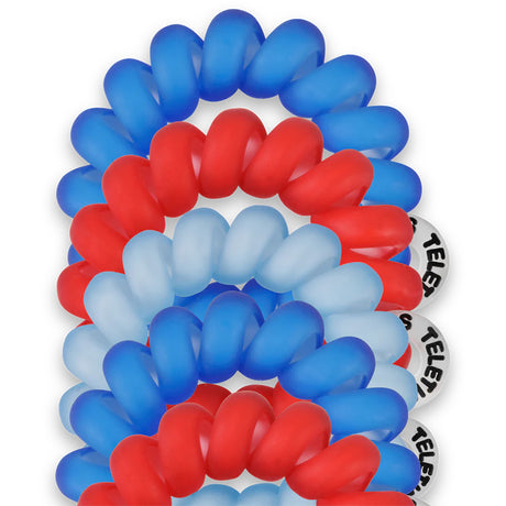 Red, white, and blue hair ties stacked on a white background