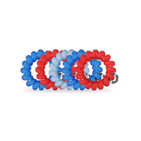 Set of red, blue, and white spiral hair ties on a white background