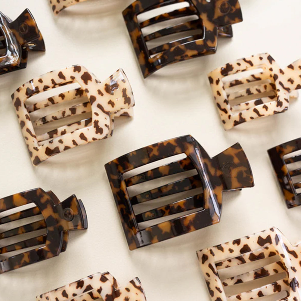 Leopard print hair clips on a white background