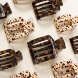 Leopard print hair clips on a white background