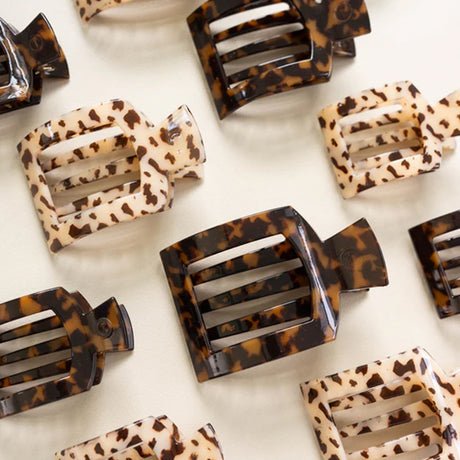 Leopard print hair clips on a white background