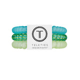 Set of green and clear hair ties with a Teleties branded label on a white background