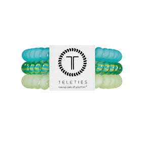 Set of green and clear hair ties with a Teleties branded label on a white background