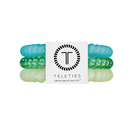 Set of green and clear hair ties with a Teleties branded label on a white background