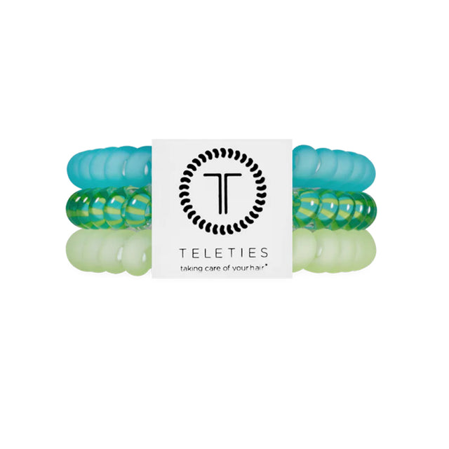 Set of green and clear hair ties with a Teleties branded label on a white background