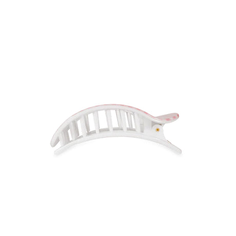 White hair clip with pink accents on a white background