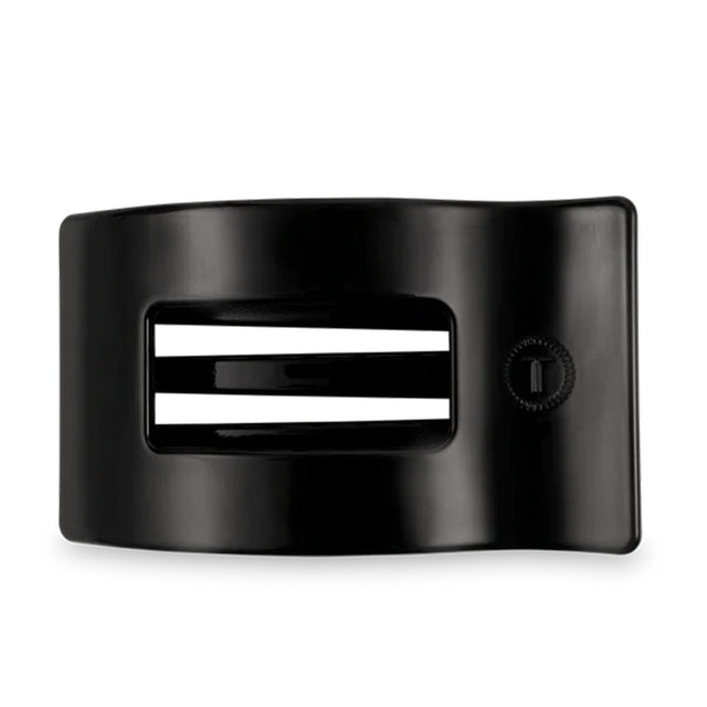Black hair clip with white stripes on a white background