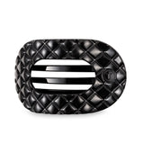 Black quilted hair clip on a light gray background