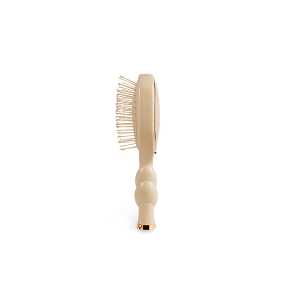 Beige hairbrush on a white background