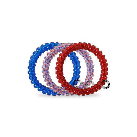Set of three hair ties in blue, red, and clear on a white background