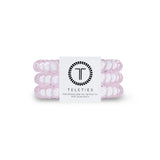 Pink hair ties with a Teleties label on a white background
