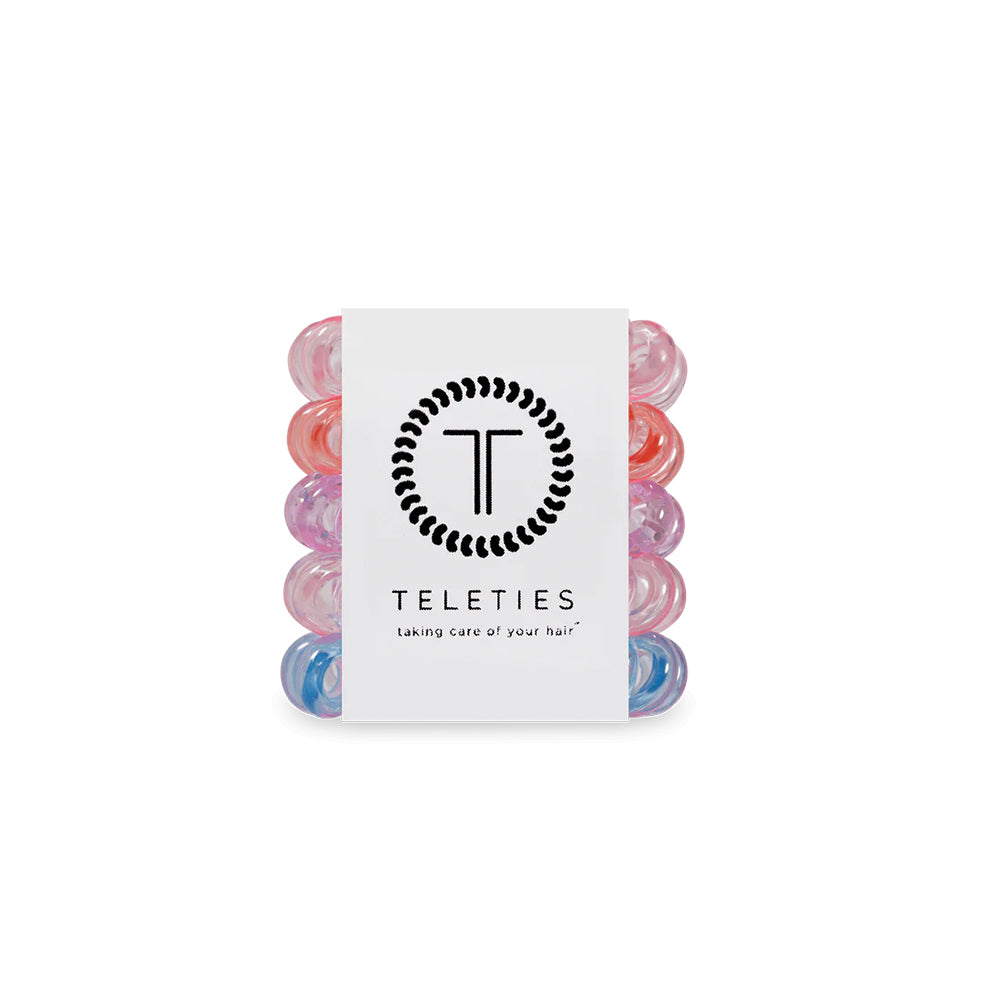 Set of colorful hair ties with a Teleties branded card on a white background