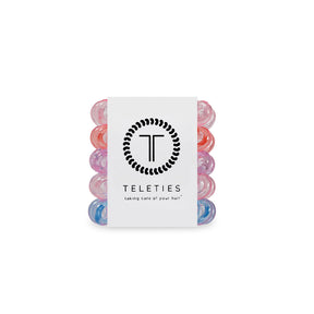 Set of colorful hair ties with a Teleties branded card on a white background