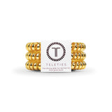 Gold hair ties with Teleties brand label on a white background