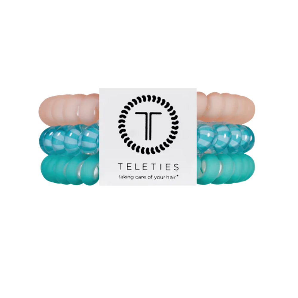 Turquoise hair ties with a brand label on a white background