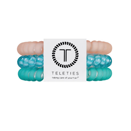 Turquoise hair ties with a brand label on a white background