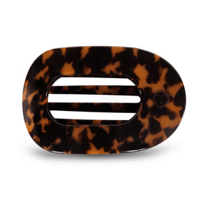Tortoiseshell patterned hair clip with a white center on a white background