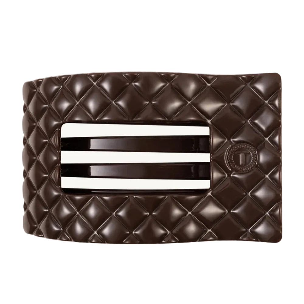 Brown quilted clutch with a silver clasp on a white background