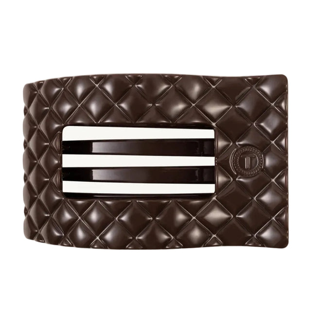 Brown quilted clutch with a silver clasp on a white background