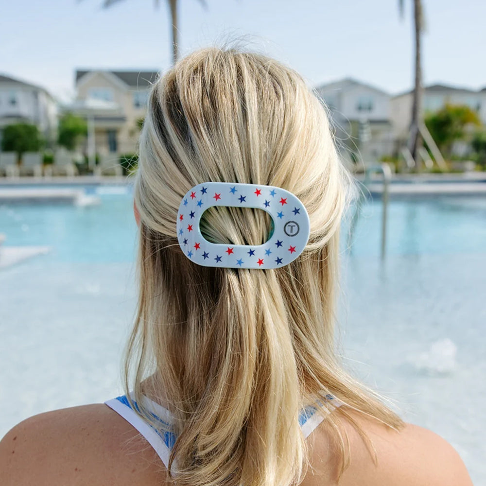 Person with a decorative hair clip by a pool
