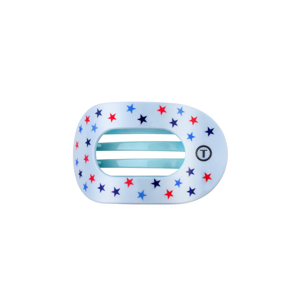 round flat hair clip with star patterns on a white background