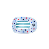 round flat hair clip with star patterns on a white background