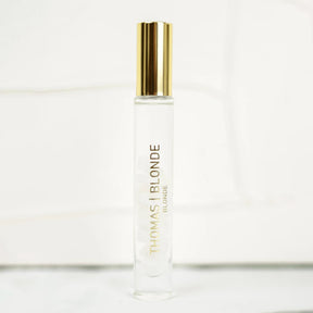 Roll-on bottle of Thomas Blonde hair product on a white background