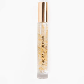 Roll-on bottle of Thomas Blonde hair product on a white background