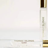 Two bottles of Thomas Blonde perfume on a white background