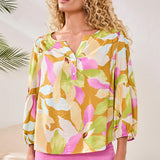 Woman wearing a colorful floral blouse with a blurred background