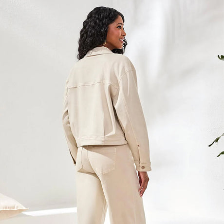 Woman wearing a beige jacket and pants on a white background