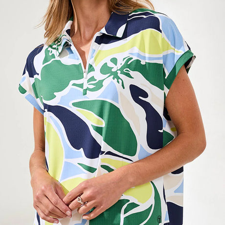 Woman wearing a colorful patterned shirt with a neutral background