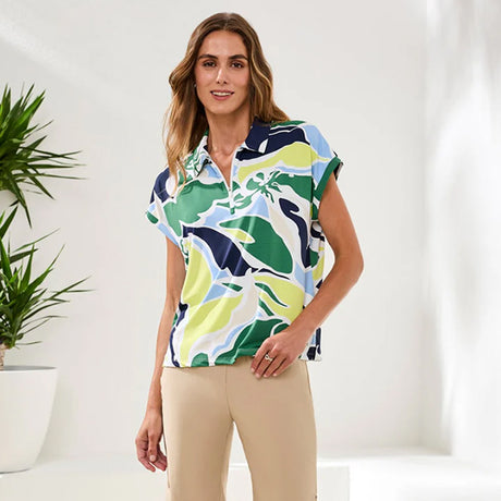 Woman wearing a colorful patterned shirt with a white background