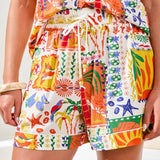 Colorful tropical-themed shorts with a white background