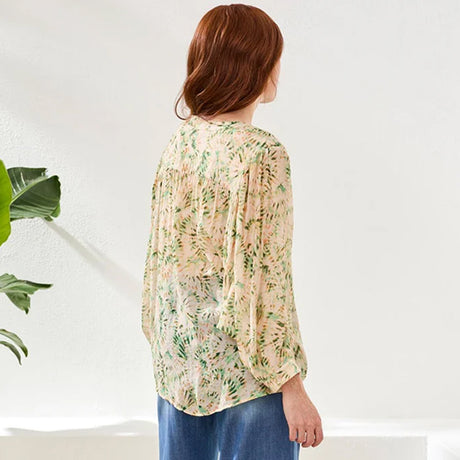 Woman wearing a floral blouse with a white background