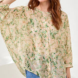 Woman wearing a floral blouse with a white background