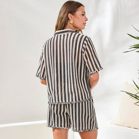 Woman wearing a black and white striped outfit with a blurred background