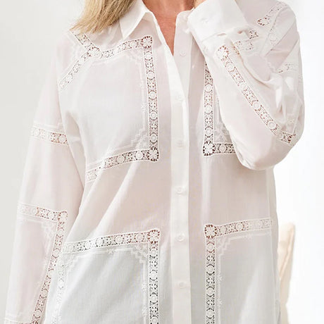White blouse with lace detailing on a white background