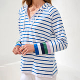 Woman wearing a blue and white striped hoodie with colorful cuffs on a white background