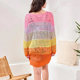 Woman wearing a colorful striped sweater in a minimal indoor setting.