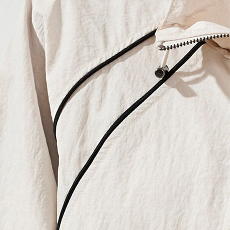 Close-up of a textured white garment with a zipper detail.