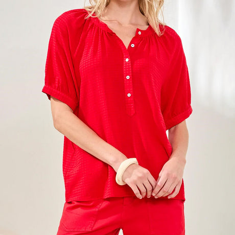 Person wearing a red shirt and pants on a plain background