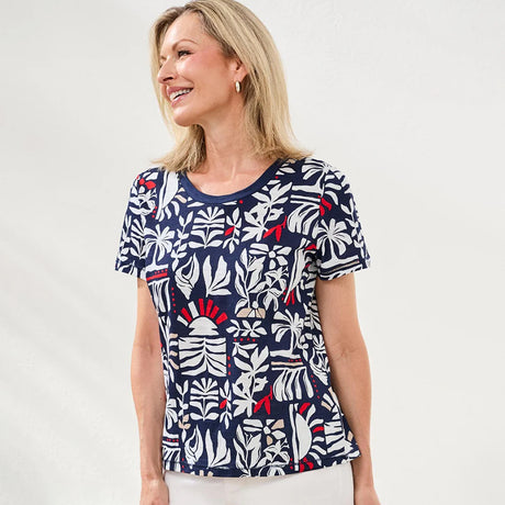 Woman wearing a navy blue t-shirt with a colorful floral pattern on a white background