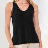 Black tank top worn by a person on a plain background