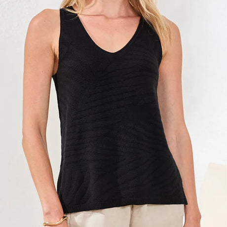 Black tank top worn by a person on a plain background